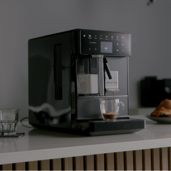 Bestir Melange commercial coffee machine brewing an espresso in a clear glass cup on a modern office counter.